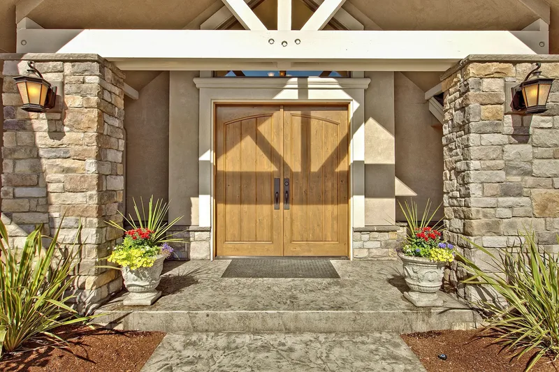 Bear Creek: Wood entry doors beneath a timber gable