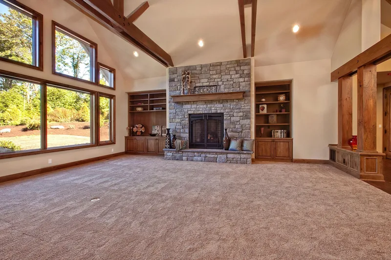 Bear Creek: Great room with a stone fireplace and tall windows