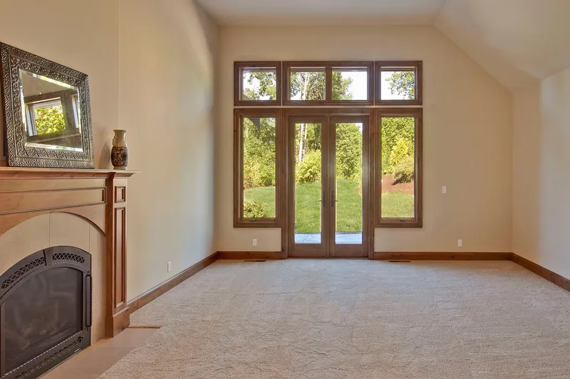 Bear Creek: Carpeted room with a fireplace and glazed doors
