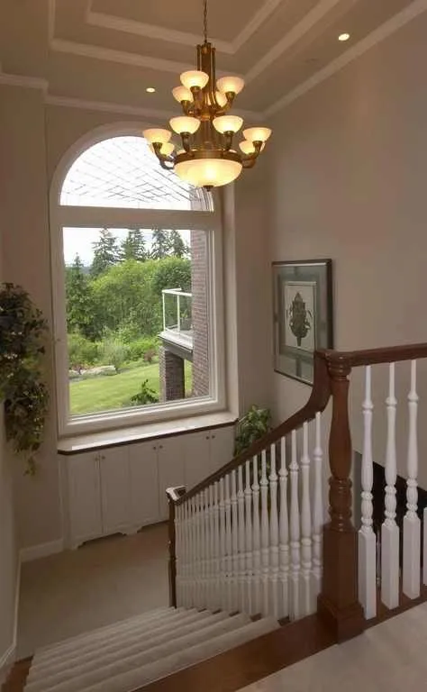 Duvall Valley: Entry hall with stair railing and a tall window