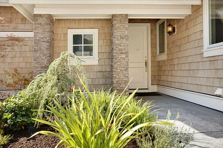 Eagle Shores, Lot 2: Front door beside a stone column and planting bed