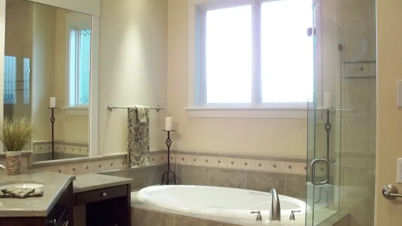 Eagle Shores, Lot 3: Bathtub beneath a window beside the glass shower