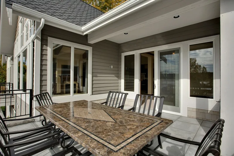 Eagle Shores, Lot 3: Outdoor dining table beside the home's glazed doors