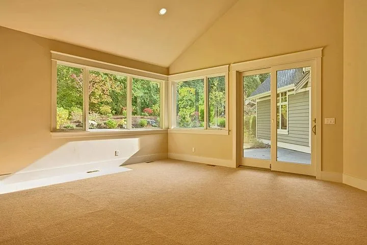 Eagle Shores, Lot 3: Carpeted room with corner windows and glazed doors