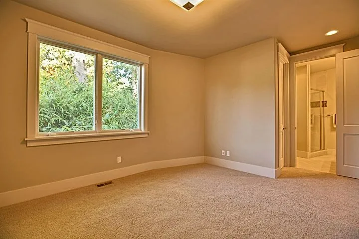 Eagle Shores, Lot 3: Carpeted room with a garden-facing window