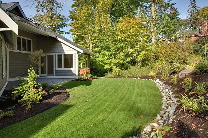 Eagle Shores, Lot 3: Lawn and planting beds beside the home