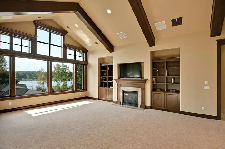 Eagle Shores, Lot 3: Great room with exposed beams, fireplace and lake-facing windows