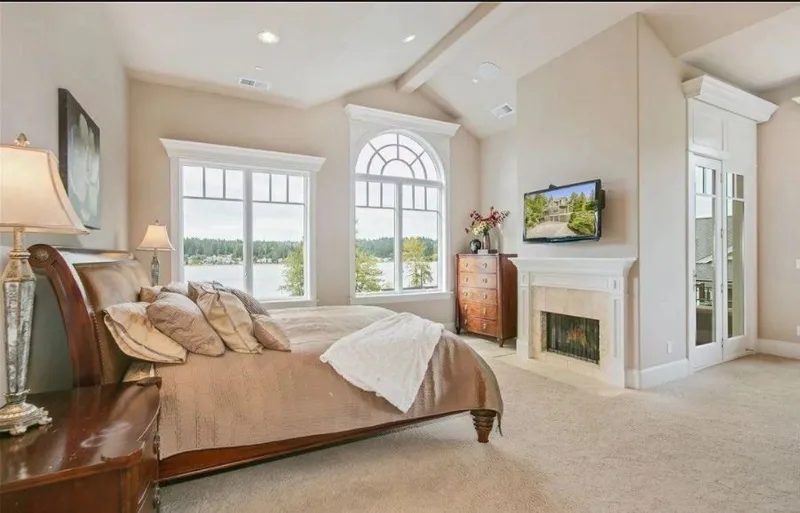 Eagle Shores, Lot 4: Bedroom with a fireplace and arched window