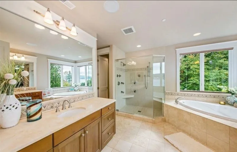 Eagle Shores, Lot 4: Bathroom with a vanity, tub and glass shower