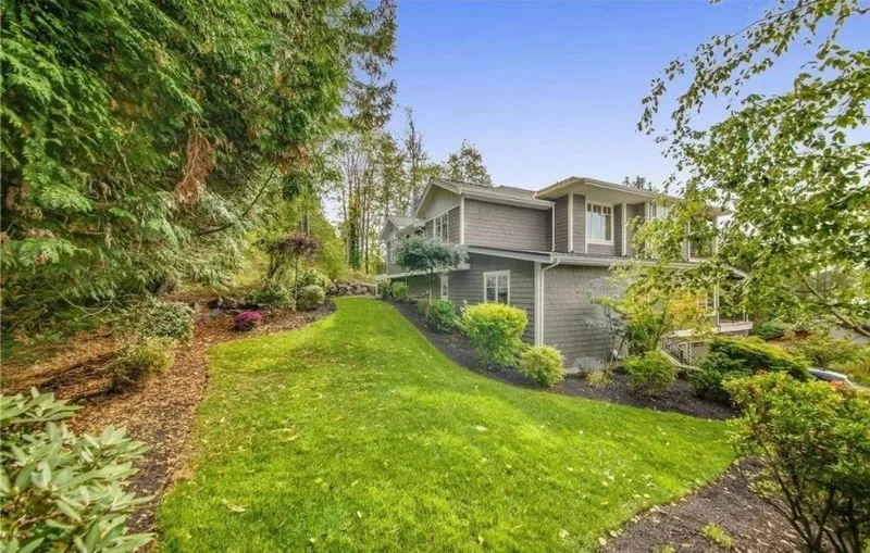 Eagle Shores, Lot 4: Lawn and planted garden beside the home