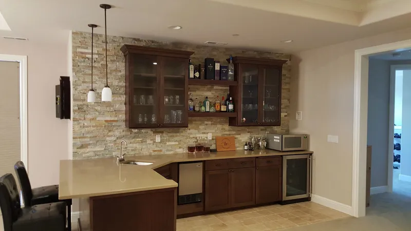 Issaquah Highlands: Bar area with wood cabinetry and tiled backsplash