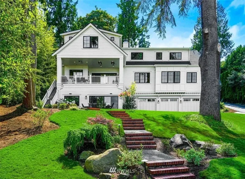 Mercer Island, Cape Cod: White exterior above a landscaped lawn and garden steps