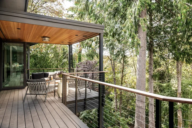 Mercer Island, indoor-outdoor: Covered deck and railings overlooking the wooded setting
