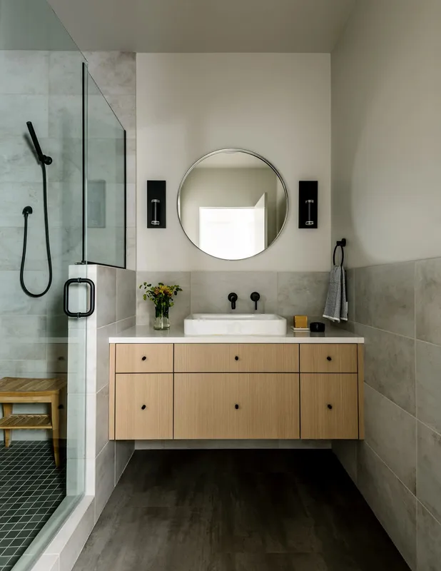 Mercer Island, indoor-outdoor: Bathroom with a glass shower and round mirror