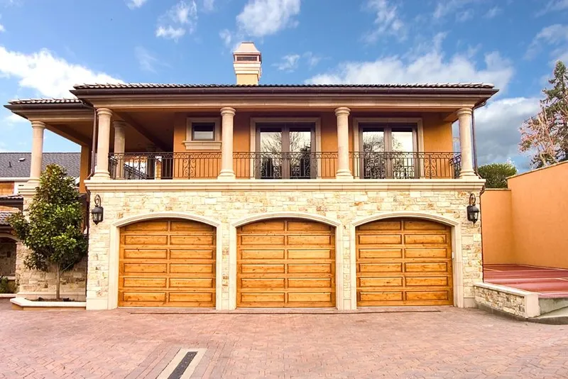Mercer Island waterfront: Three garage doors beneath a covered upper terrace