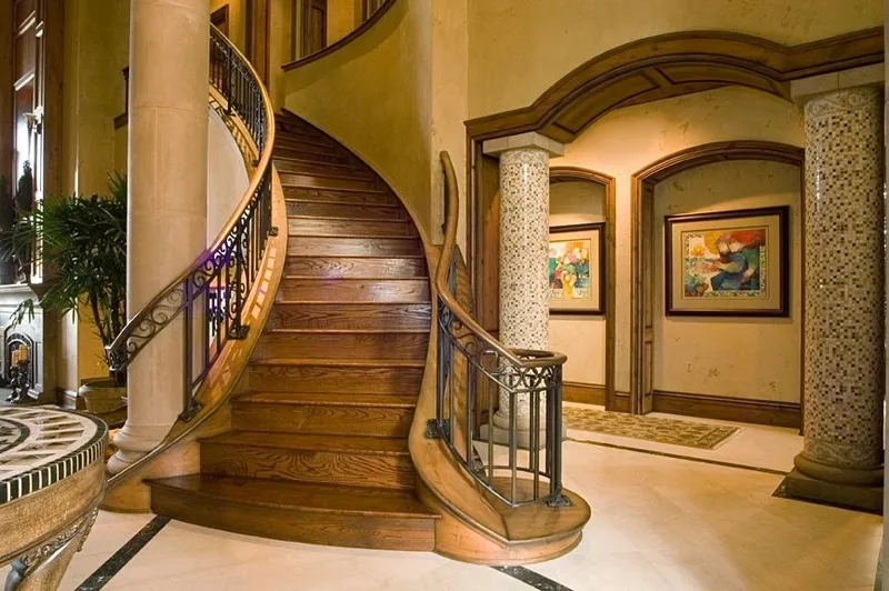 Mercer Island waterfront: Curved wood staircase with iron railings and mosaic-clad columns