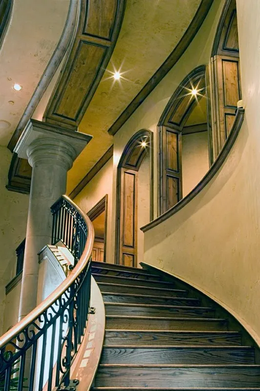 Mercer Island waterfront: Curved staircase rising toward the upper gallery