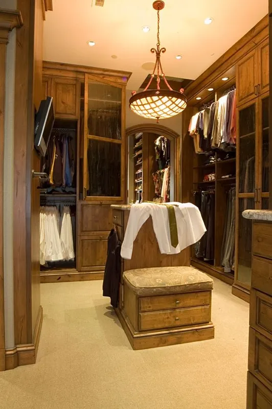 Mercer Island waterfront: Dressing room with dark wood cabinetry and a central seat