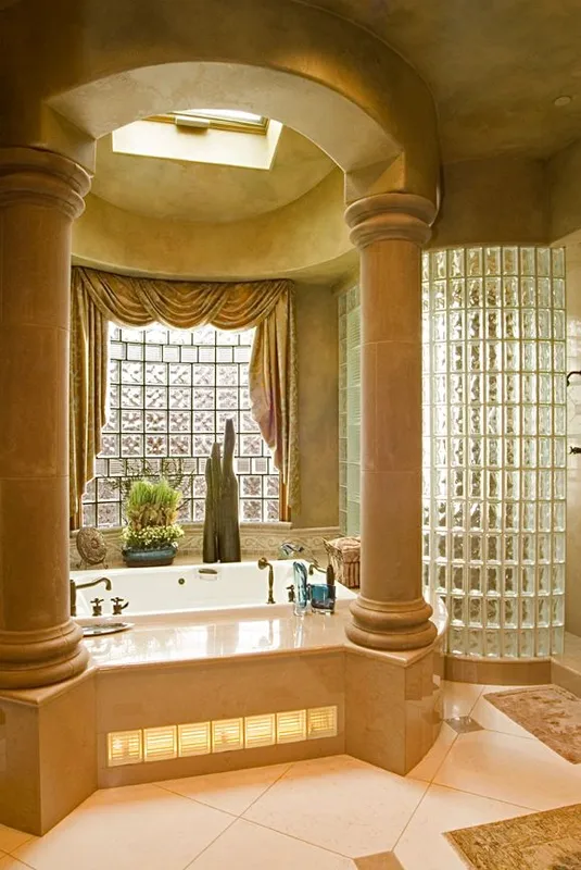 Mercer Island waterfront: Soaking tub beneath an arched window and skylight