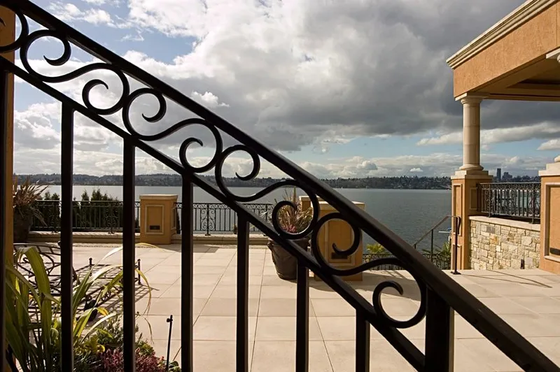 Mercer Island waterfront: Iron railing framing a view across the terrace and water