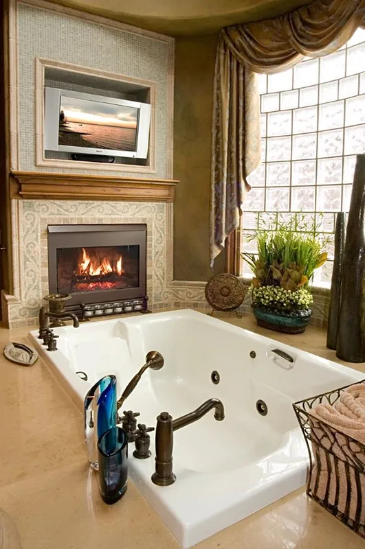 Mercer Island waterfront: Bathroom tub beside a fireplace and glass-block window