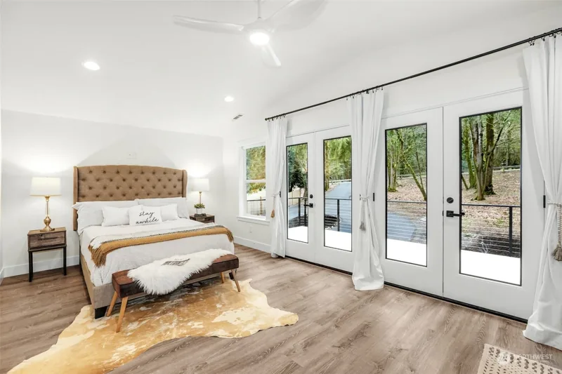 Bedroom with glass doors opening toward the yard