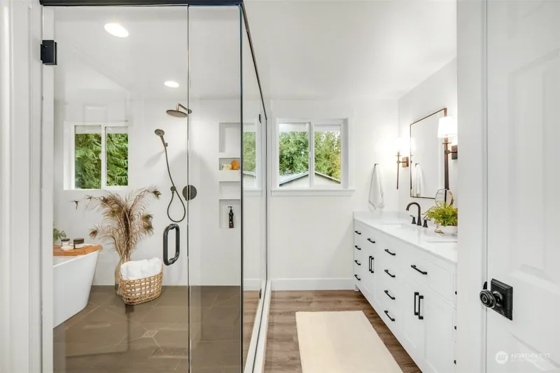 Bathroom with a glass shower, freestanding tub and long vanity