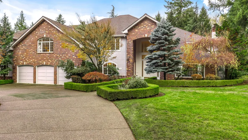 Brick-front Woodinville home and landscaped front lawn