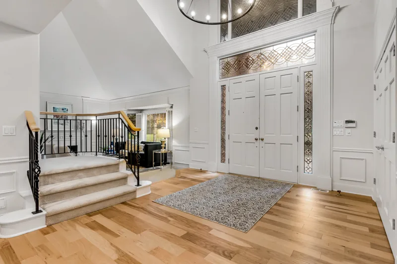 Entry hall with double doors and an open staircase