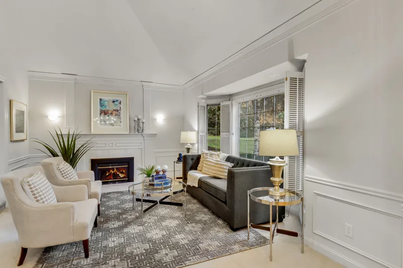 Living room with a fireplace and tall windows