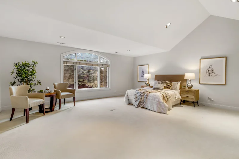 Bedroom with a sitting area and garden windows