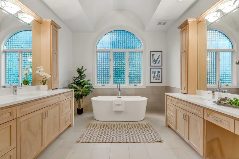 Bathroom with a freestanding tub and arched window