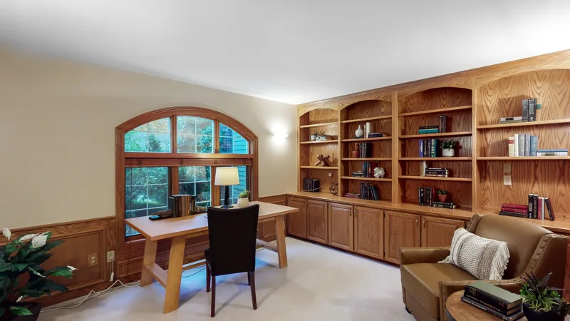 Wood-paneled study with built-in shelving