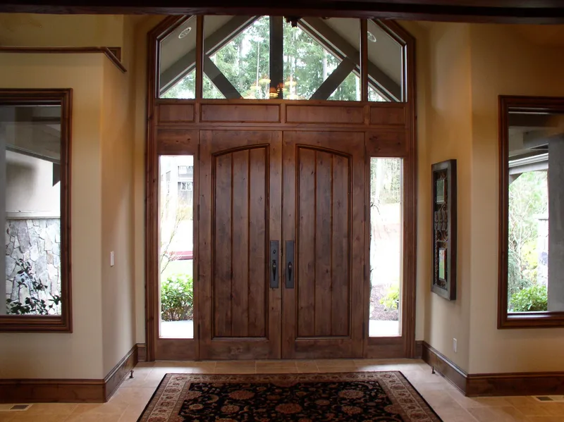 Woodinville Craftsman: Wood front door with sidelights and a transom window