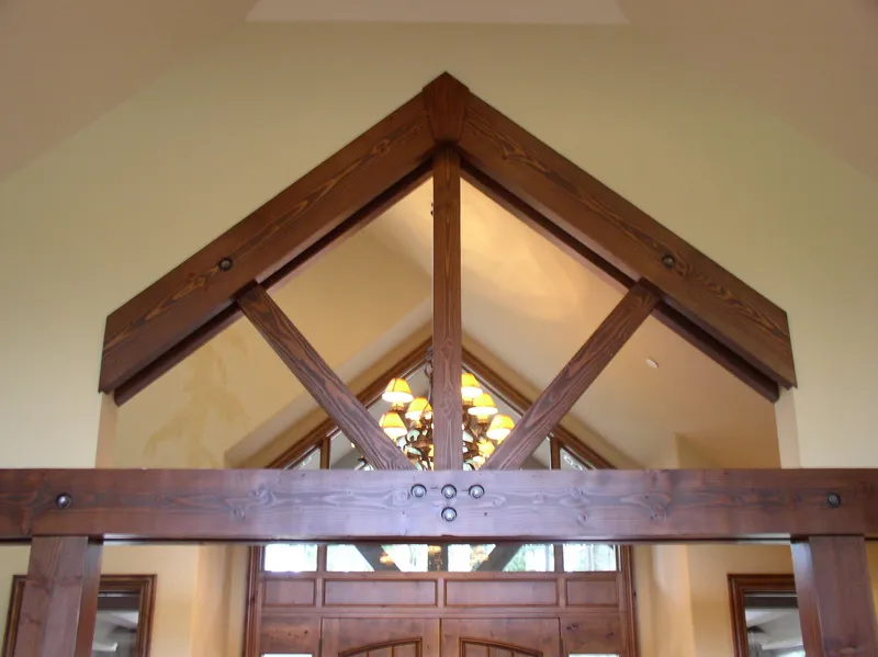 Woodinville Craftsman: Exposed timber truss and metal connection details above the entry
