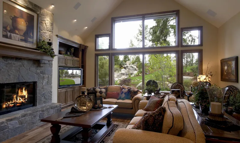 Woodinville Craftsman: Living room seating beside the stone fireplace and tall windows