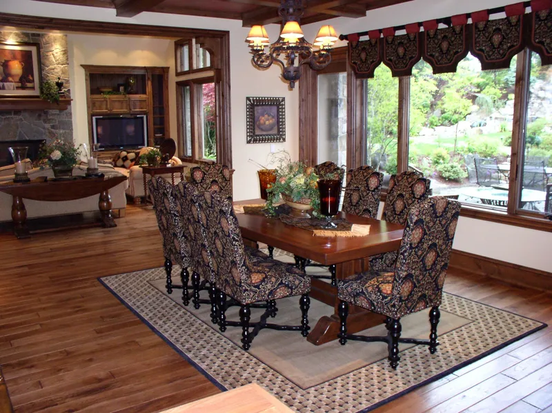 Woodinville Craftsman: Dining table beside broad windows and built-in cabinetry