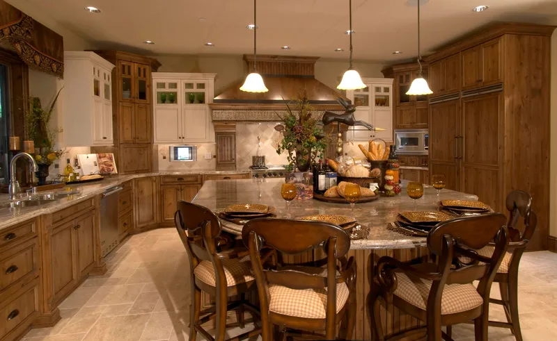 Woodinville Craftsman: Kitchen with a broad island, wood cabinetry and pendant lighting