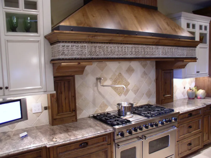 Woodinville Craftsman: Range wall with a broad decorative hood and tiled backsplash