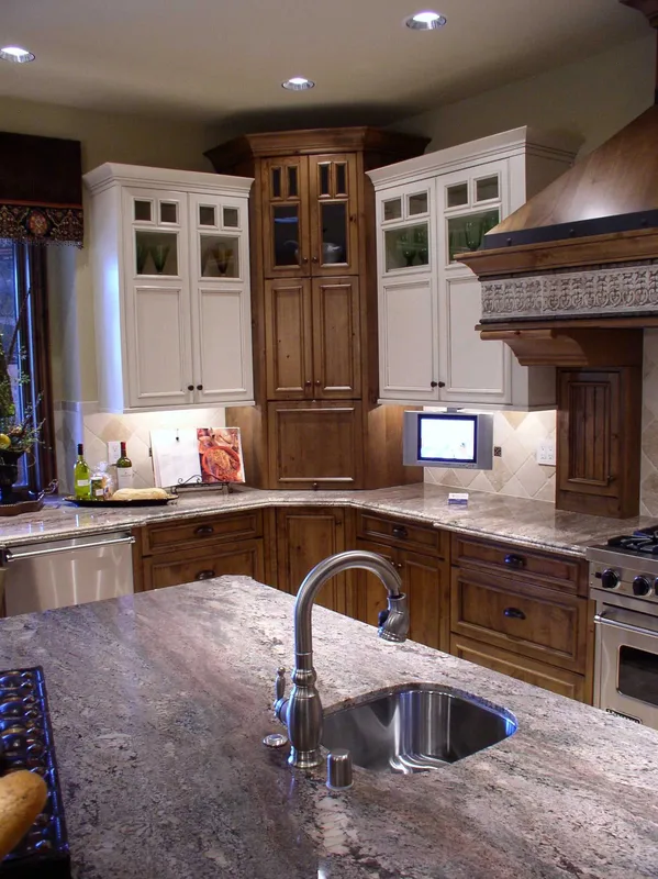 Woodinville Craftsman: Island sink beneath pendant lights and tall cabinetry