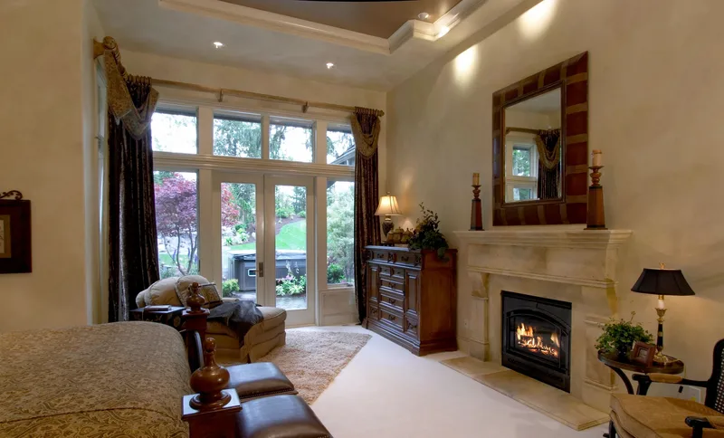 Woodinville Craftsman: Bedroom sitting area with a fireplace and garden doors