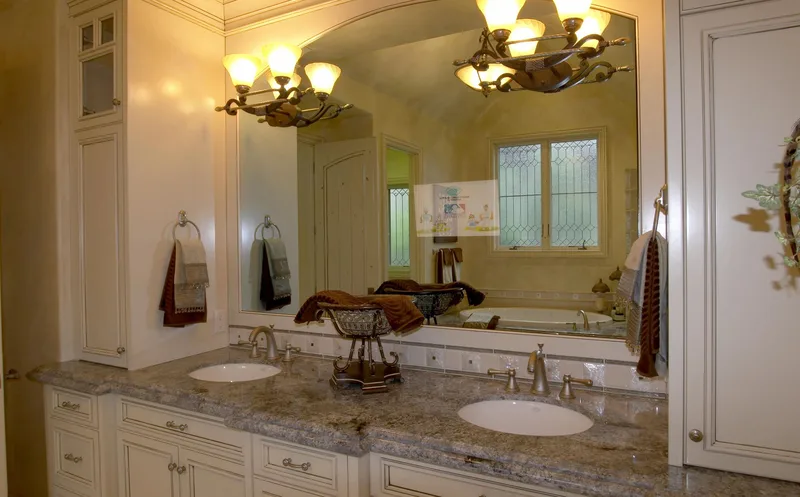 Woodinville Craftsman: Bathroom vanity and mirror reflecting a window-side sitting area