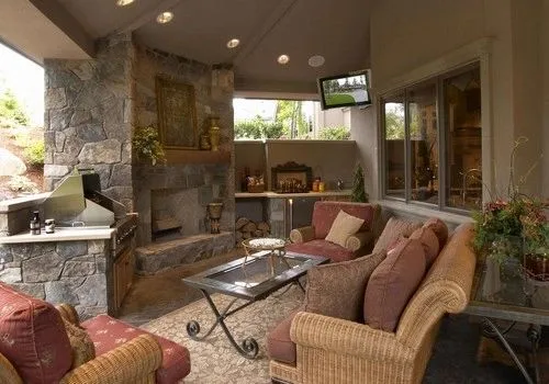 Woodinville Craftsman: Covered outdoor lounge with a stone fireplace
