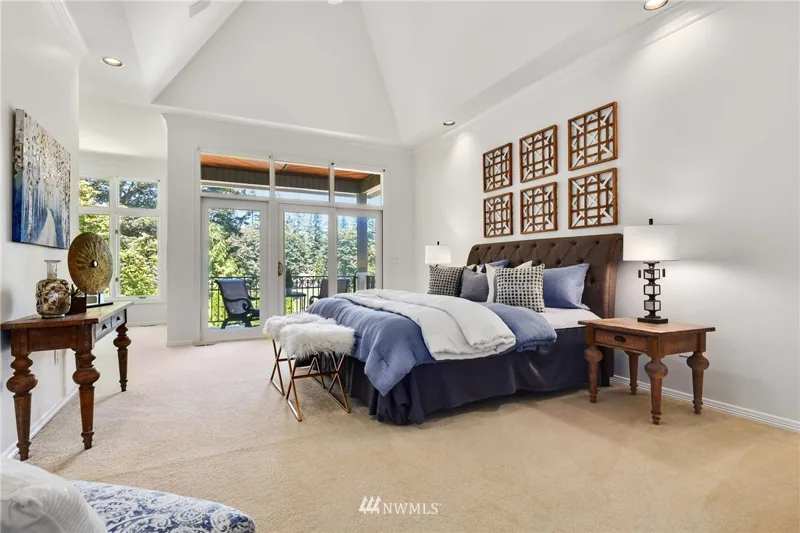 Bedroom with a vaulted ceiling and garden-facing windows