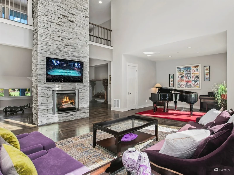 Stone fireplace between the great room and piano alcove