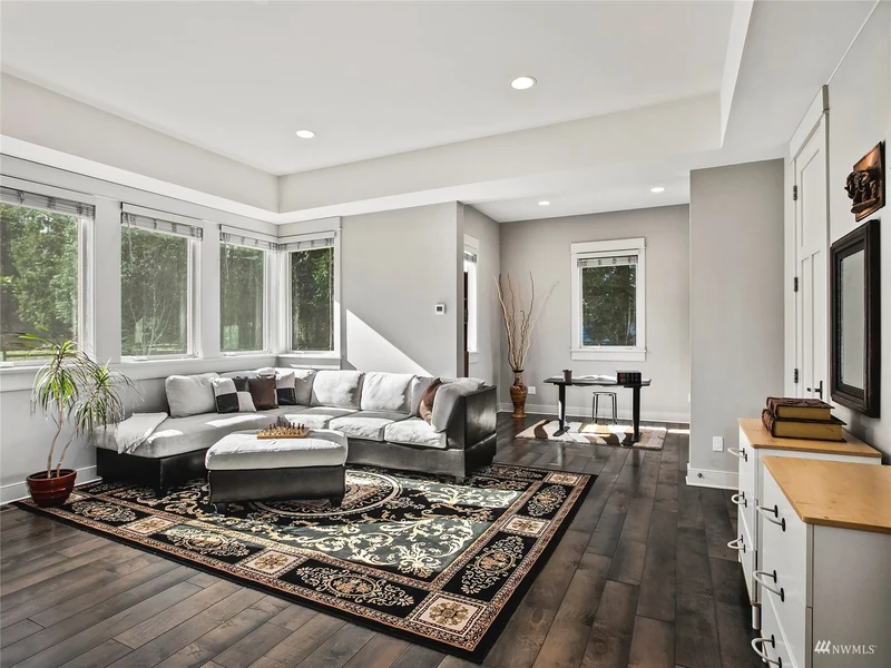 Sitting room with a sectional sofa and broad windows