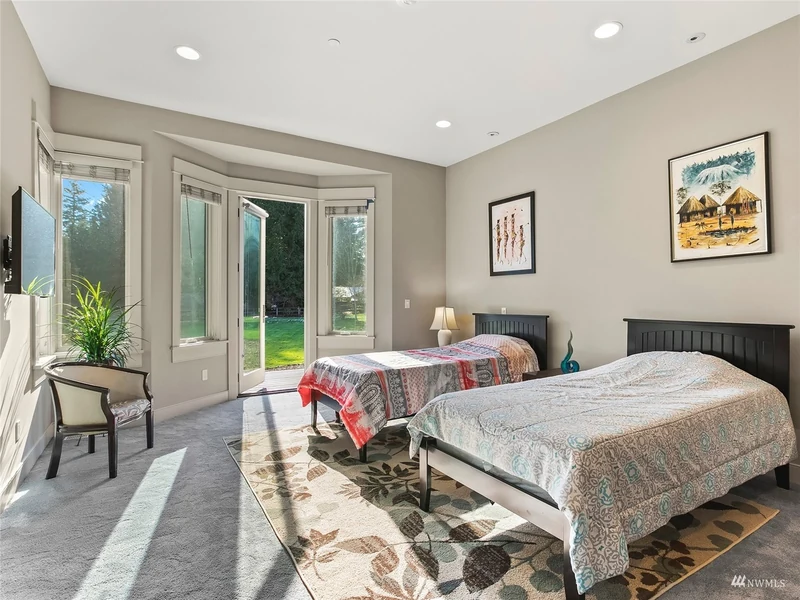 Bedroom with twin beds and French doors opening to the lawn