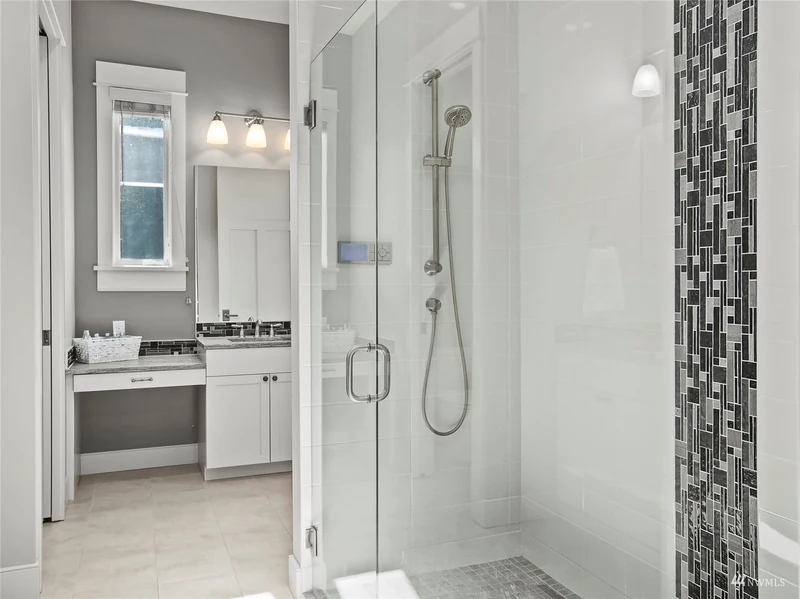 Bathroom with a glass shower and a separate vanity area