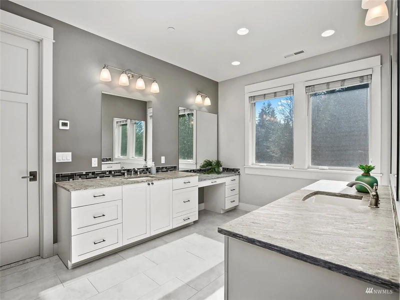 Bathroom with a soaking tub, double vanity and garden windows