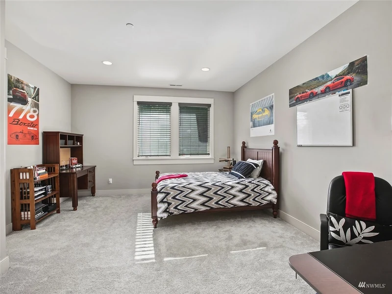 Bedroom with a desk and built-in display cabinetry